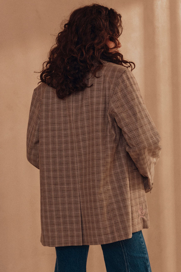 Back view of Arizona Blazer in Check showing centre back vent and placement embroidery detail at hem