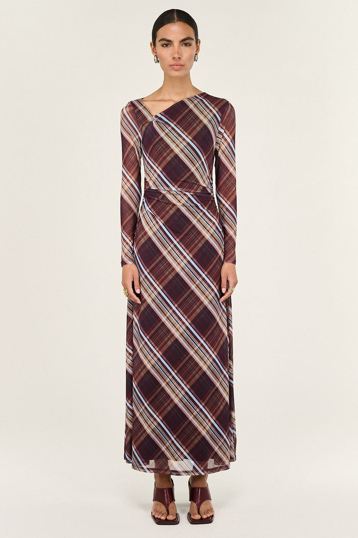 Woman wearing a plaid dress on a white background