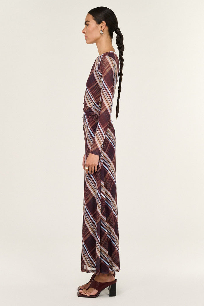 Woman wearing a patterned dress on a white background
