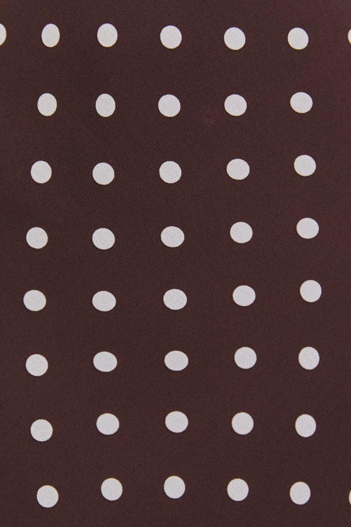 Close-up of a brown fabric with white polka dots
