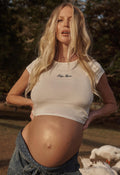 Spell Baby Mama Tee in white women's ribbed cotton crop top with embroidered script, worn during pregnancy