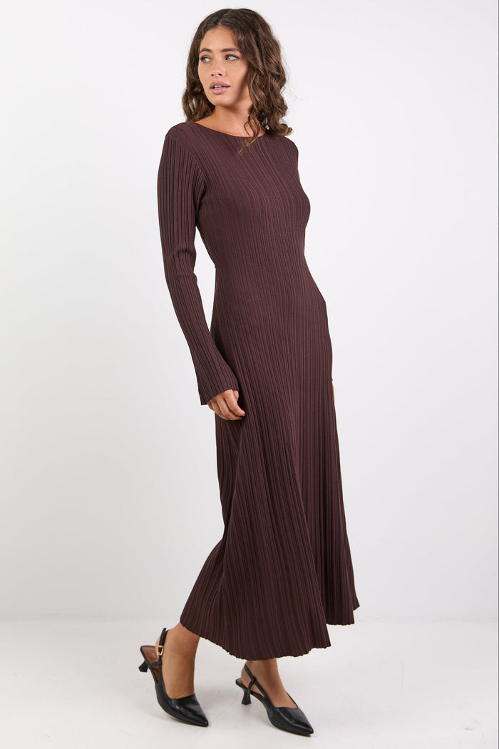 Woman wearing a long brown dress on a white background