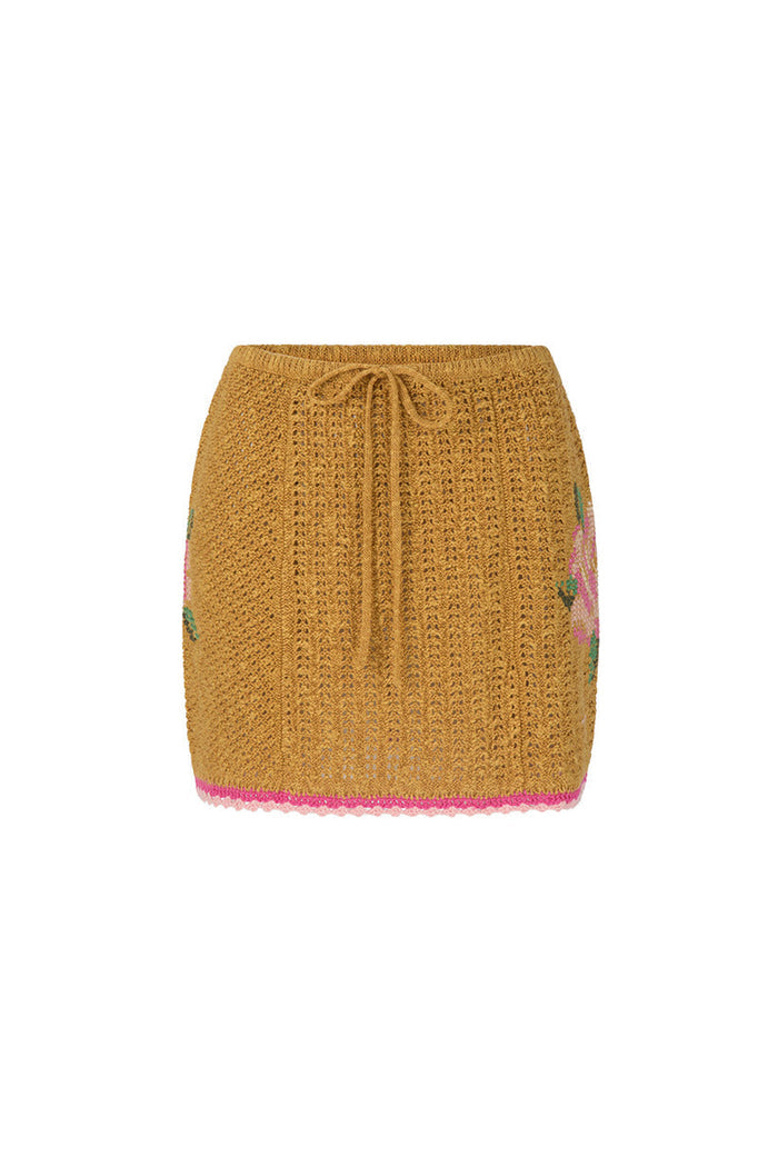 Mustard knit mini skirt flat lay, drawstring waist, pink floral embroidery and pink crochet trim hem