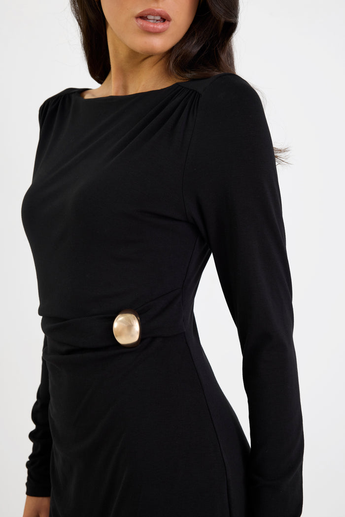 Black dress with a gold button detail on a white background