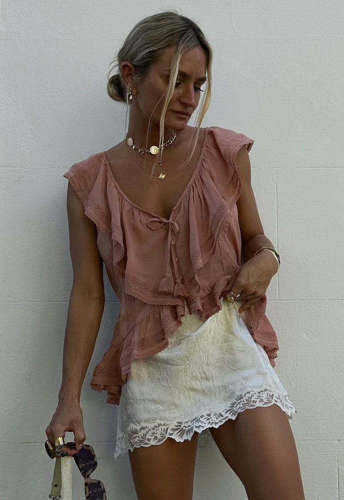 Dubois Bias Mini Skirt in Pearl styled with pink ruffle top, showing lace-trim hem and white Naia acetate fabric