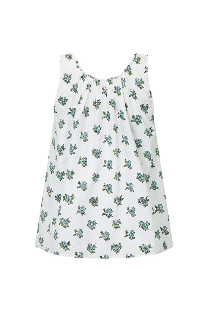 Flat lay of white block-printed top with blue floral clusters, part of the Fable Lounge Set in Wild Poppy