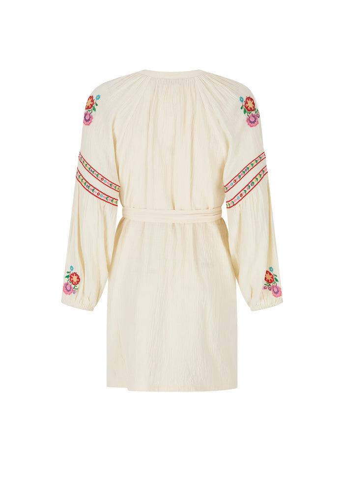 An off-white long-sleeve mini dress with colorful floral and geometric embroidery on the sleeves and neckline, shown against a plain white background.