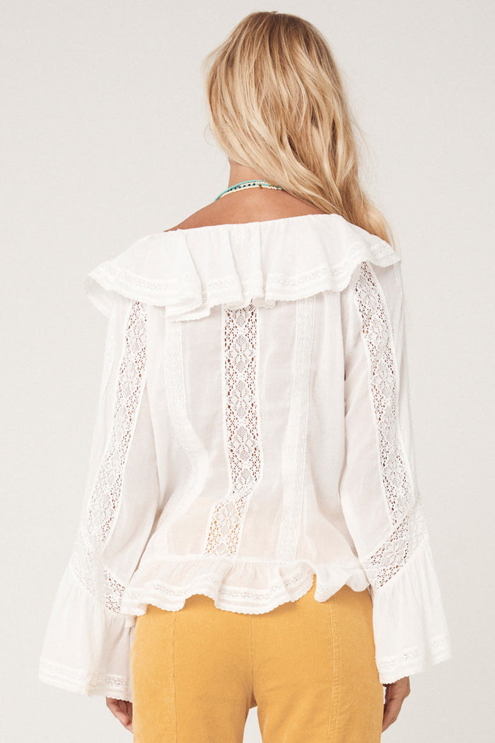 Back view of white Fleur Lace Frill Blouse showing insert lace panels, ruffle collar, and flutter frill hem