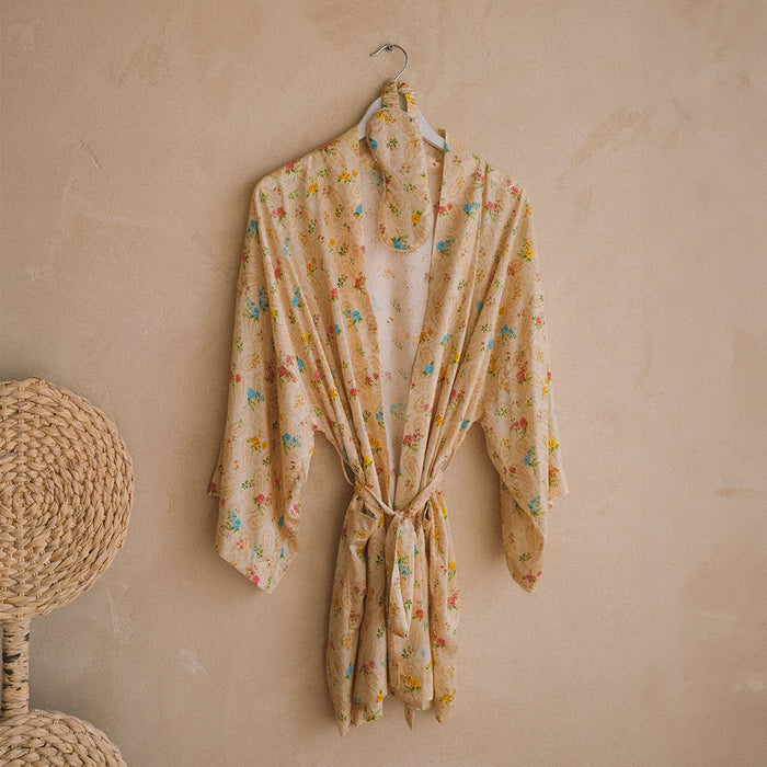 Spell women's Fleur Robe and Eye Mask Set in Macaroon, yellow floral robe with tie waist, hung on wall