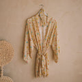 Spell women's Fleur Robe and Eye Mask Set in Macaroon, yellow floral robe with tie waist, hung on wall
