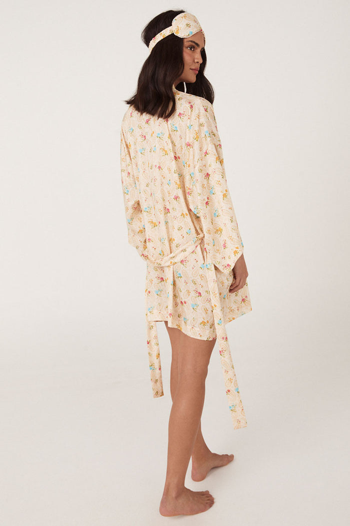 Side-back view of floral robe with tie waist and matching eye mask in cream Macaroon print