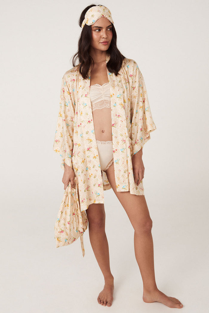 Fleur robe and eye mask set in macaroon floral print laid flat on light background