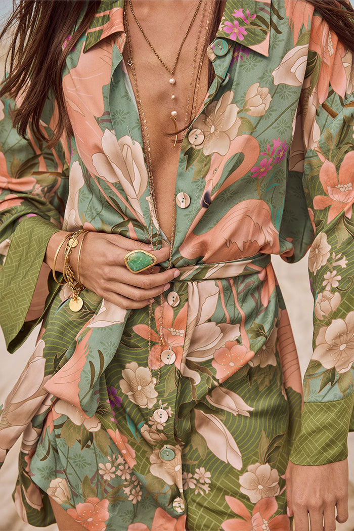 Close-up of sage flamingo floral print, mother-of-pearl buttons, and point collar on shirt dress