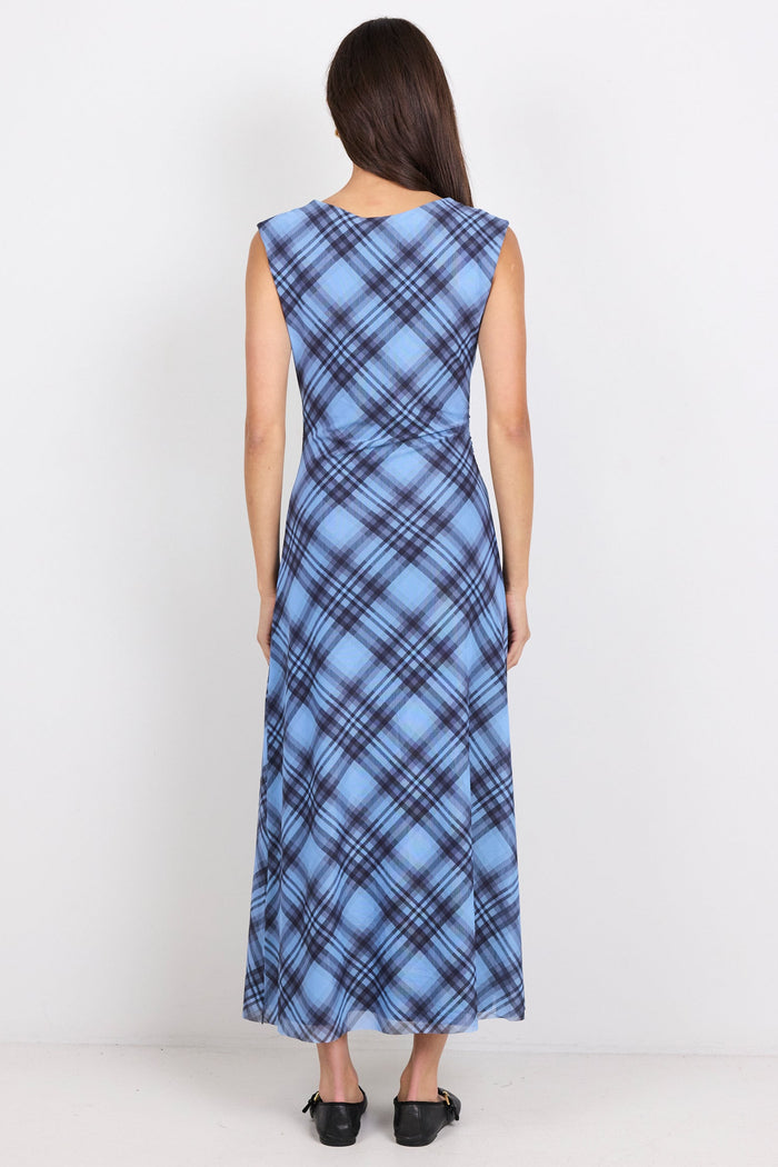 Woman wearing a blue plaid dress on a white background