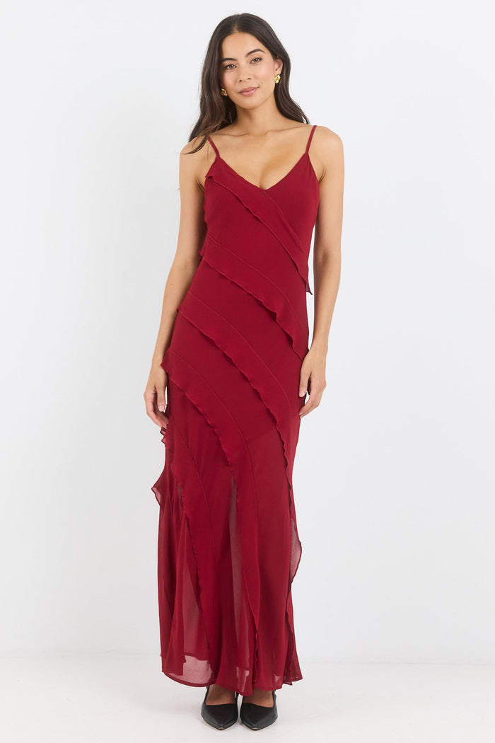 Woman wearing a burgundy evening gown on a white background
