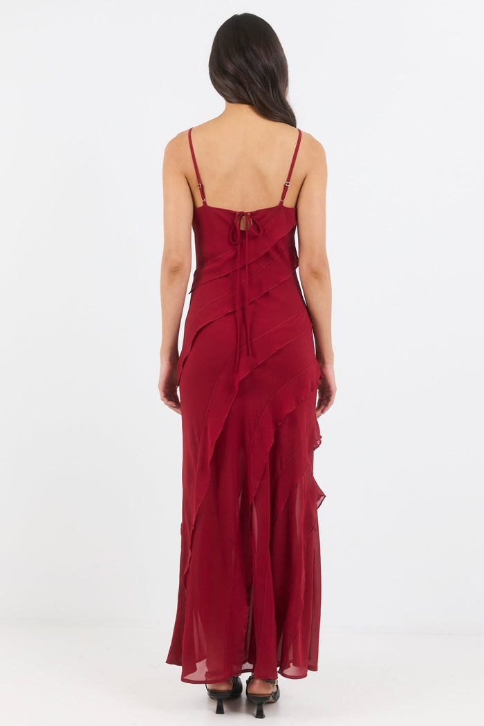 Woman wearing a burgundy evening gown on a white background