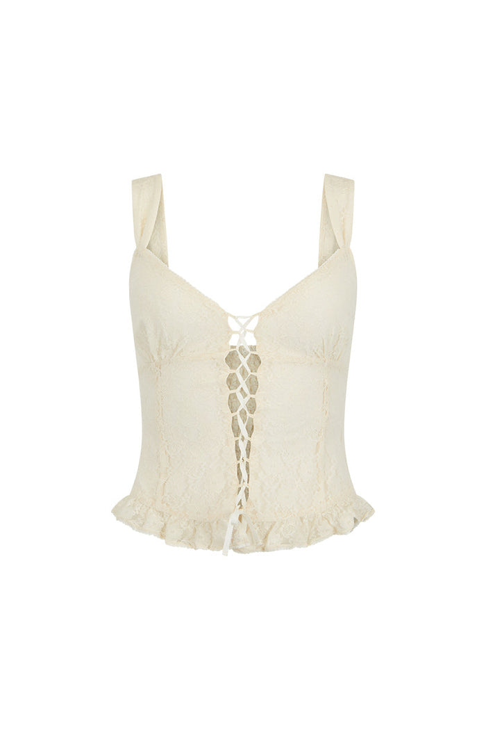 Front flat lay of antique white lace cami with front lacing detail, frill hem, and back shirring on white background