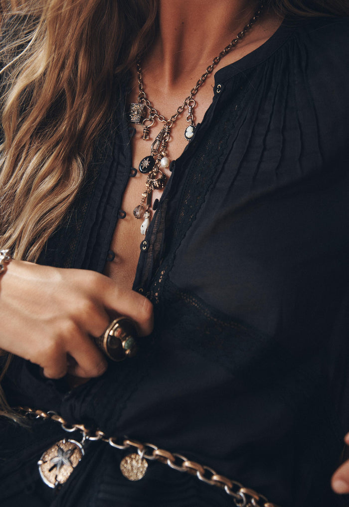 Model wearing Hera Lace Blouse in Vintage Black, showing lace trim detail and front button opening