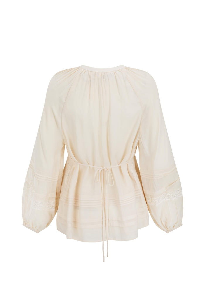 Macadamia Hera Lace Blouse flat lay, back view showing waist tie, pintuck hem and lace-trim sleeves on white