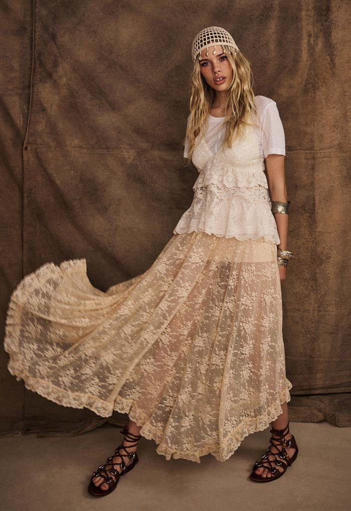 Model wearing Labyrinth Lace Maxi Skirt in Peach Bliss, front view showing hi-lo lace hem and movement