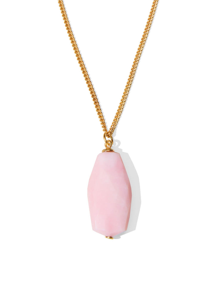 Close-up of pink opal stone pendant on gold curb chain, showing faceted stone set with gold pinpoint detail