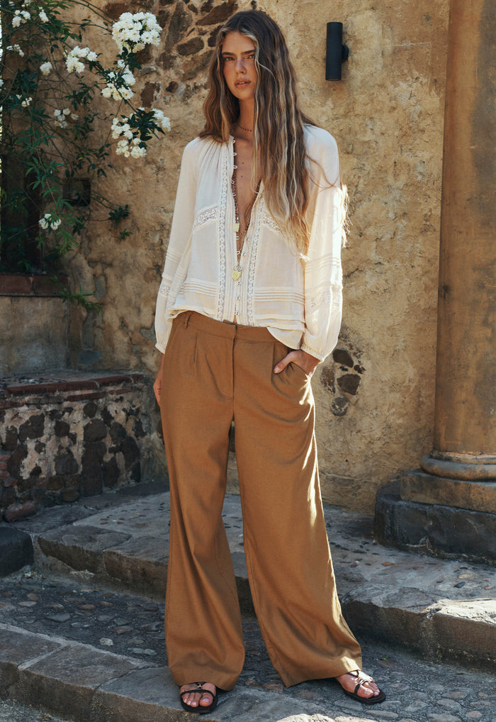 Spell women's London Pleated Pant in Tan hemp-blend wide-leg trousers with front pleats, worn by a model