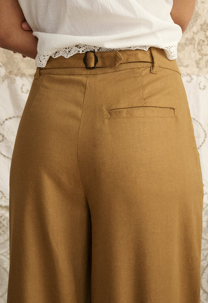 Back view of tan hemp-blend wide-leg pant showing back welt pocket and adjustable waist buckle detail