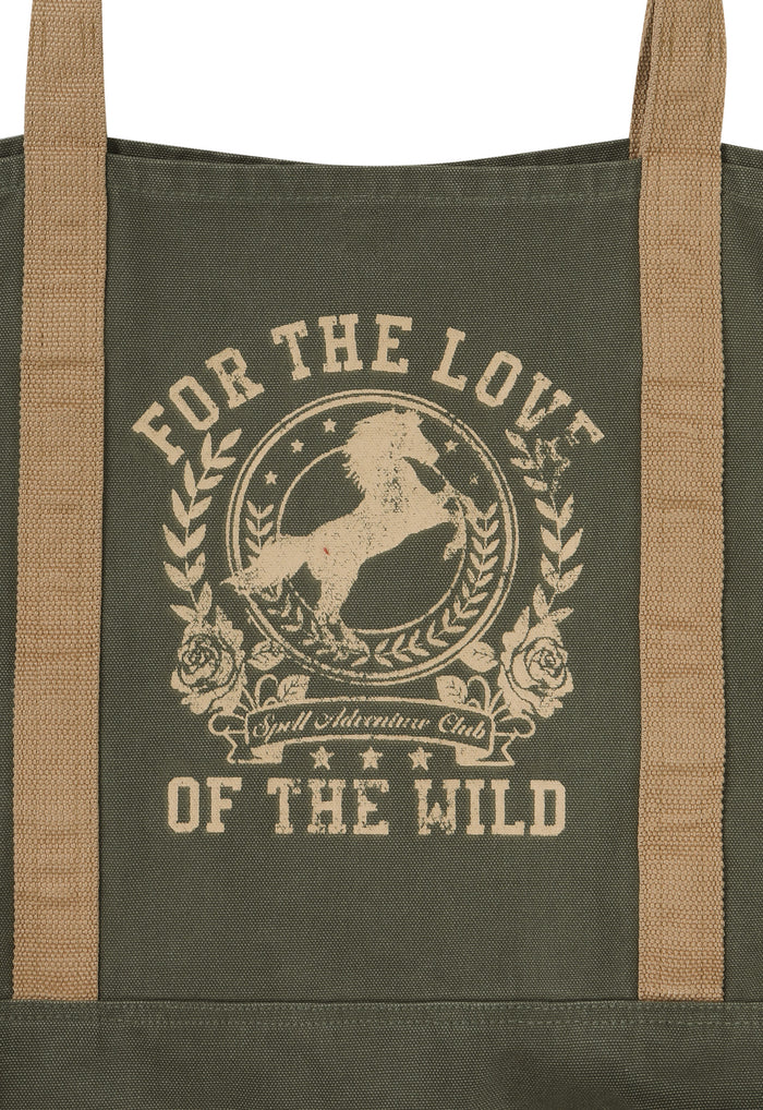 An olive green canvas tote bag with tan webbing handles and a beige graphic print featuring a horse and the text 'FOR THE LOVE OF THE WILD' and 'Wild Adventure Club'.