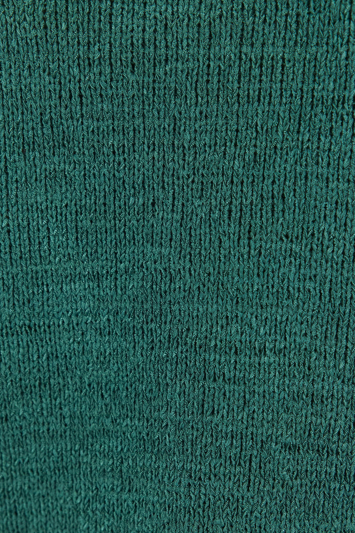 Close-up of a textured green fabric with a ribbed pattern