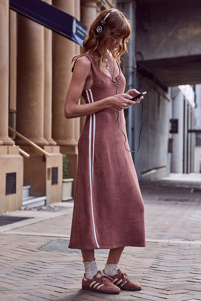 Model in Luciana Terry Maxi Dress, side view showing white contrast stripe and centre front neck ruching