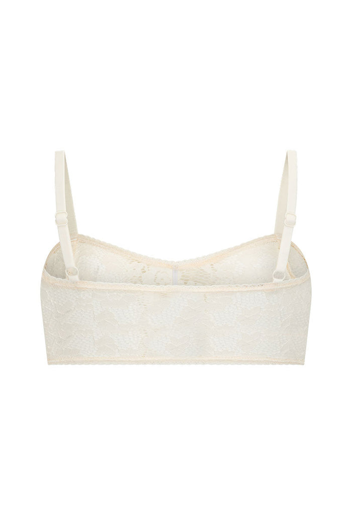 Back flat lay of cream lace bralette with adjustable straps, lace trim on neckline and underbust