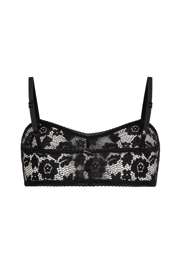 Black floral lace bralette with adjustable straps and scalloped trim, flat lay on white background