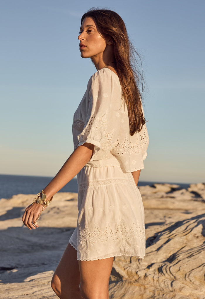 Side view of Maiden Lace Mini Skirt, showing inserted lace panels, broderie anglaise hem and elasticated waist