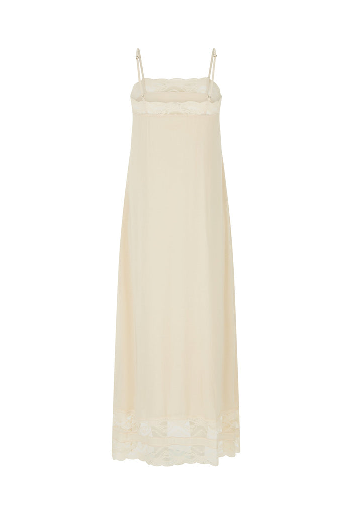 An off-white maxi slip dress with thin straps, a ruffled lace-trimmed bodice, and a matching lace hem, shown against a plain white background.