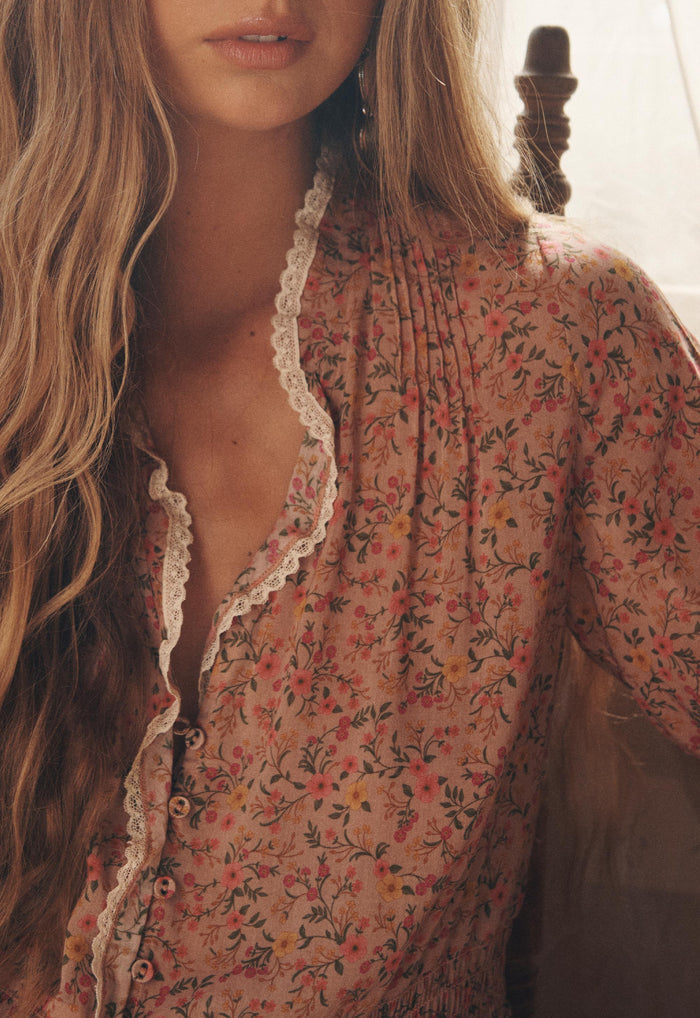 Close-up of lace-trim neckline and pintuck detail on Pink Posey floral organic cotton blouse