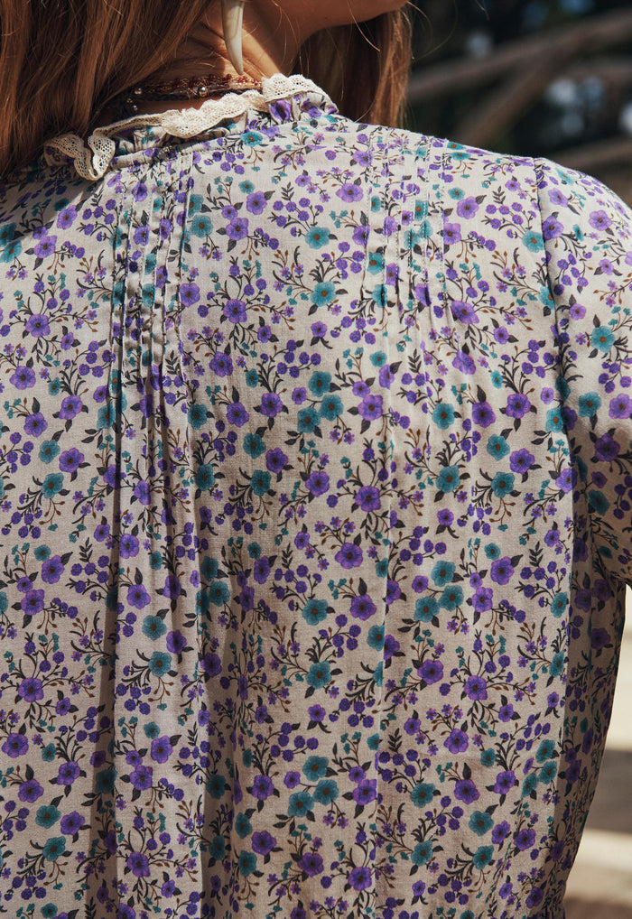 Back view of Violet Fields floral blouse showing pintuck details at yoke and lace-trim neckline