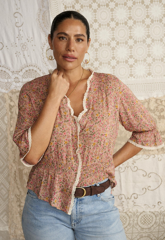 Model wearing Mimi-Rose Blouse front view, lace-trim neckline and shirred waist visible, styled with jeans