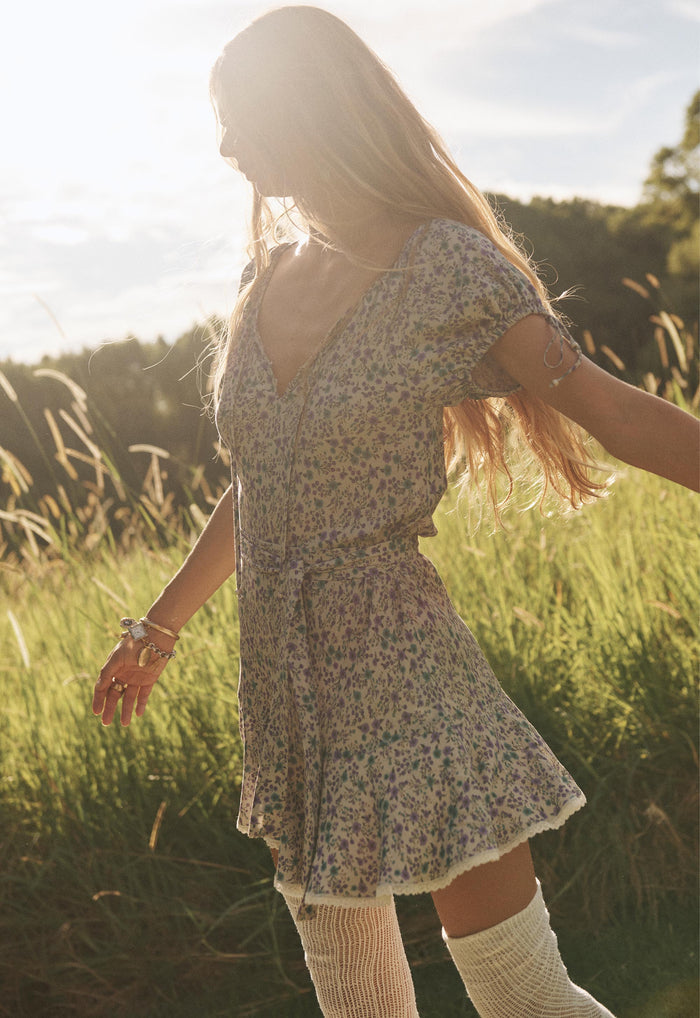 Back view of Mimi-Rose Mini Dress in Violet Fields, showing V-back, lace-trim hem ruffle and tie waist
