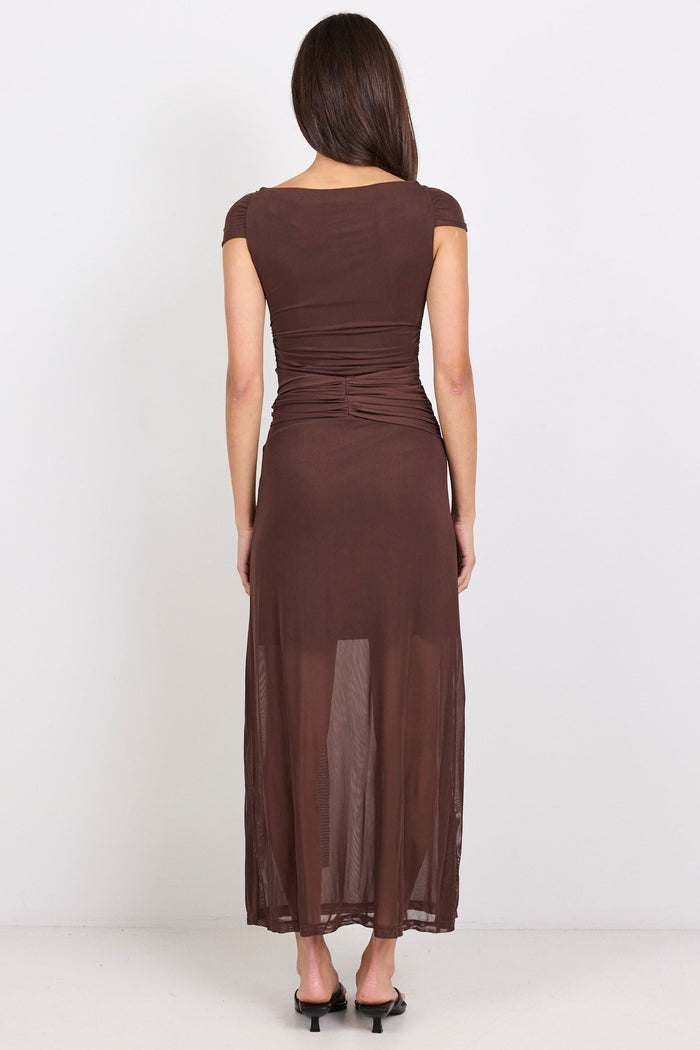 Woman wearing a brown dress on a white background
