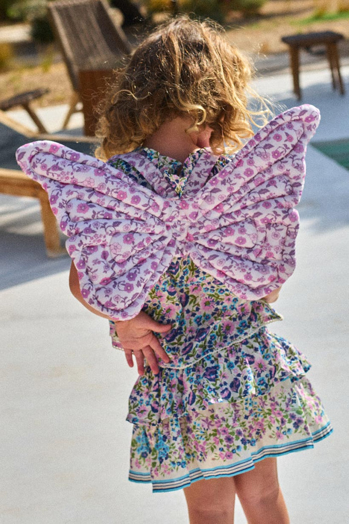 Back view of child wearing lilac floral quilted fairy wings with purple flower print detail