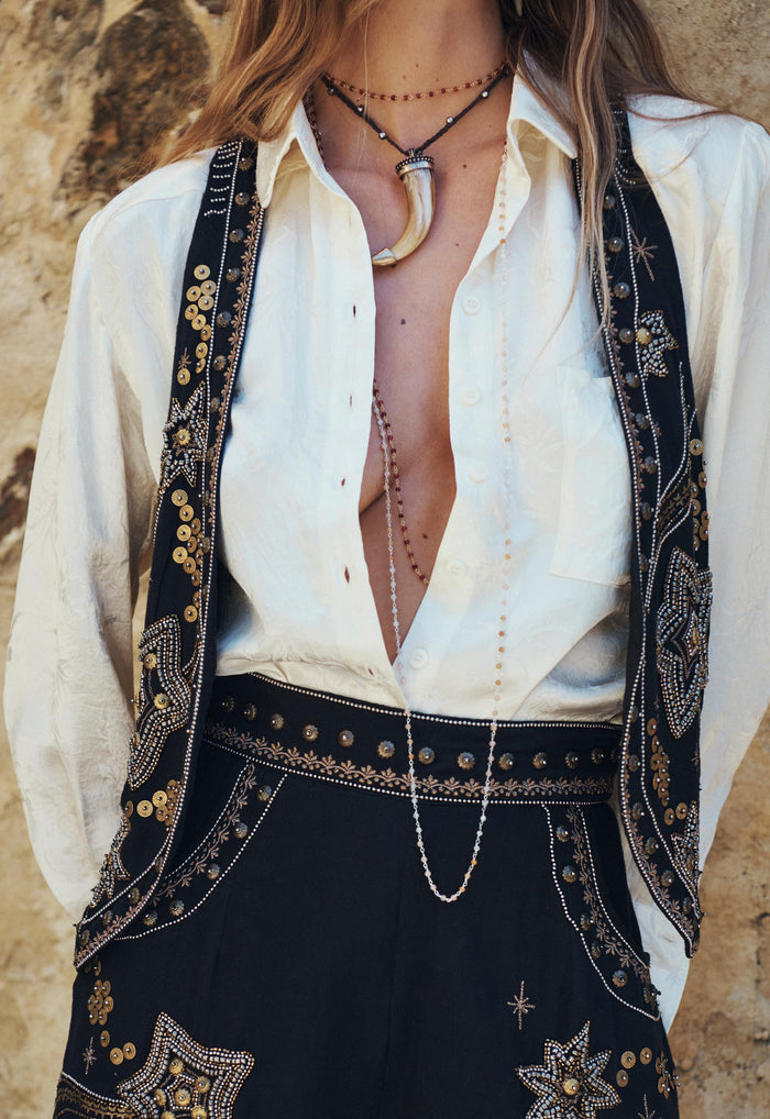 Close-up of a model wearing Night Sky Vest in Midnight, showing gold sequin and bead embellished front trim detail