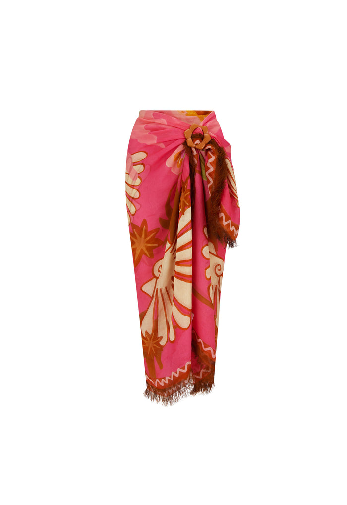 Oceana Travel Scarf in Coral draped as sarong, pink modal with floral print, frayed hem and flower buckle, white background