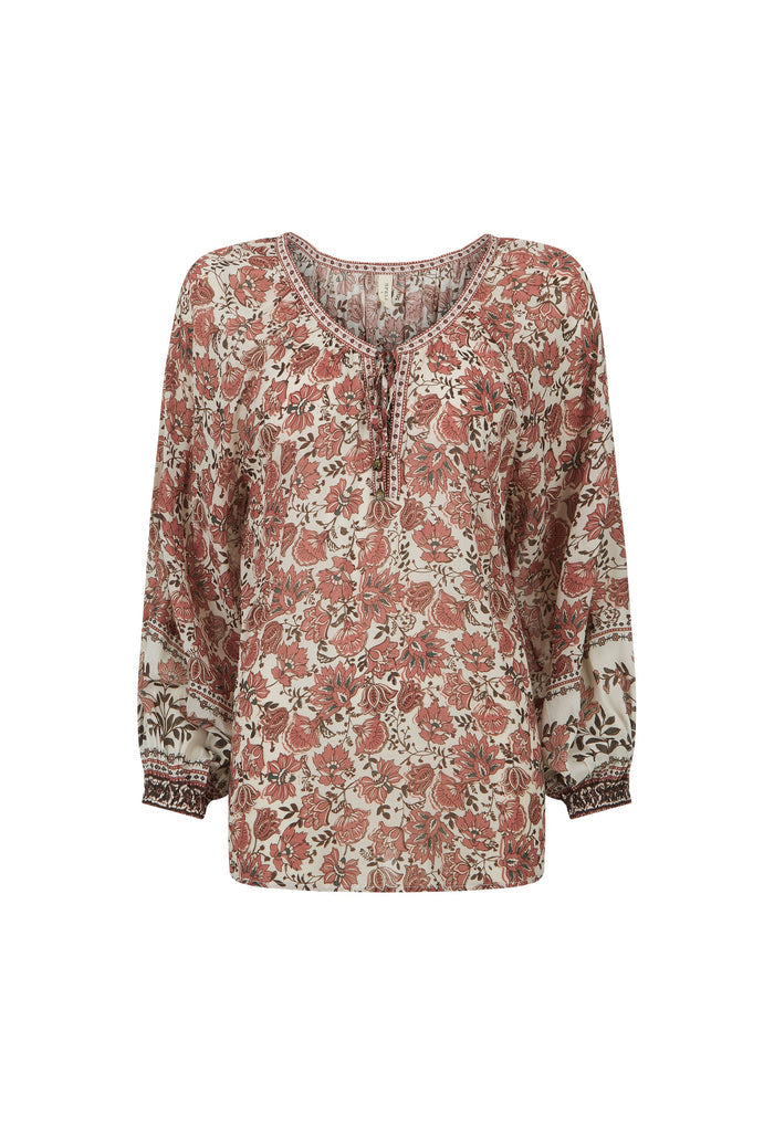A long-sleeve bohemian-style blouse with a dense floral and paisley print in dusty rose, terracotta, and dark brown on a cream background, featuring a split neckline with tie details.