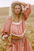 Model wearing rose Poison Peach Blouse, front view, lace-trim neckline and cuffs with tie sleeves, wheat field setting