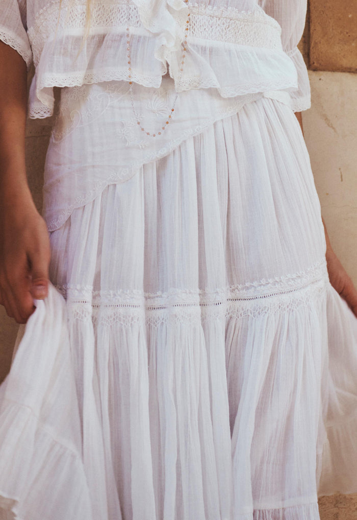 Close detail of lace trim bands and gathered tiers on white organic cotton Prairie Midi Skirt
