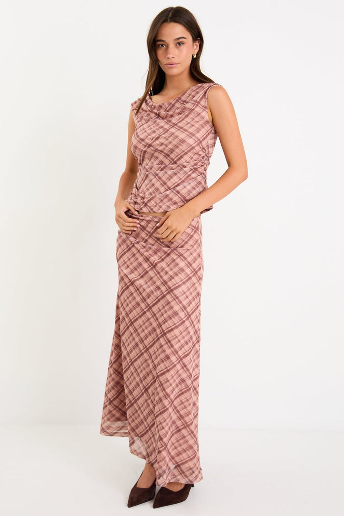 Model wearing a blush check mesh panelled maxi skirt with a soft elastic waist and floaty silhouette