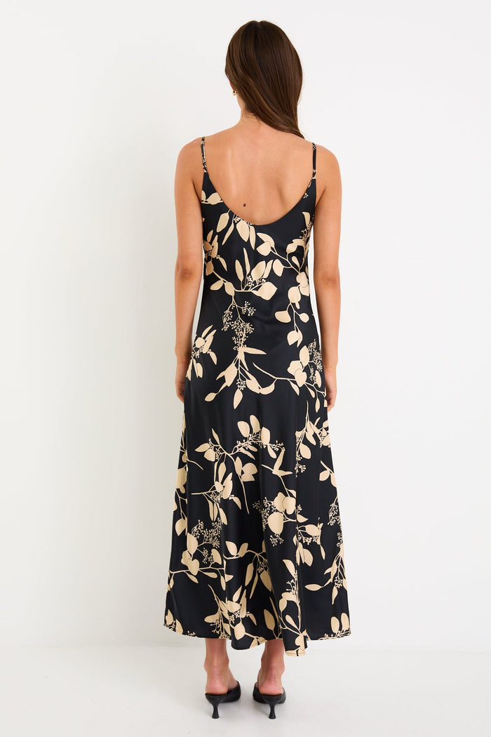 Woman wearing a black floral dress on a white background