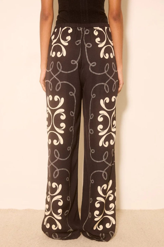 Woman wears a black and white print matching set