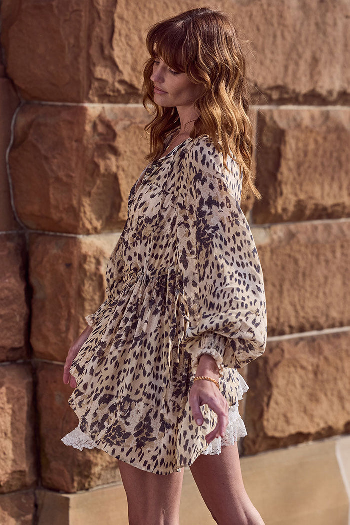 Side view of Snow Leopard Asymmetric Blouse showing lace hem trim, shirred cuffs and side tie detail