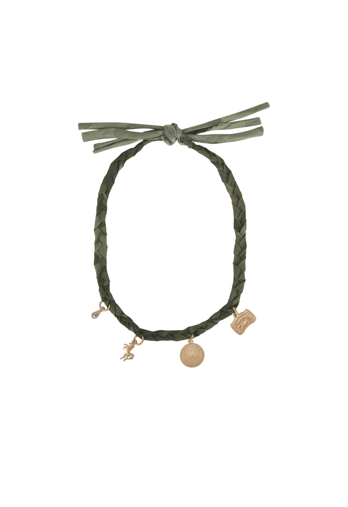 An olive green braided cord bracelet with a knotted tie at the top and three dangling charms in a gold tone, shown against a plain white background.